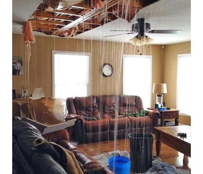 water pouring through ceiling into living room